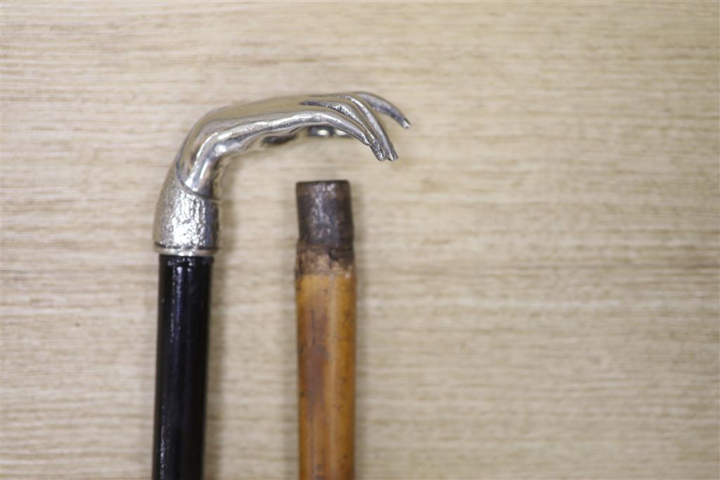 A Chinese silver-mounted malacca cane and a plate mounted ebonised stick